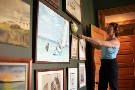 Image of Rebekah hanging a gallery wall