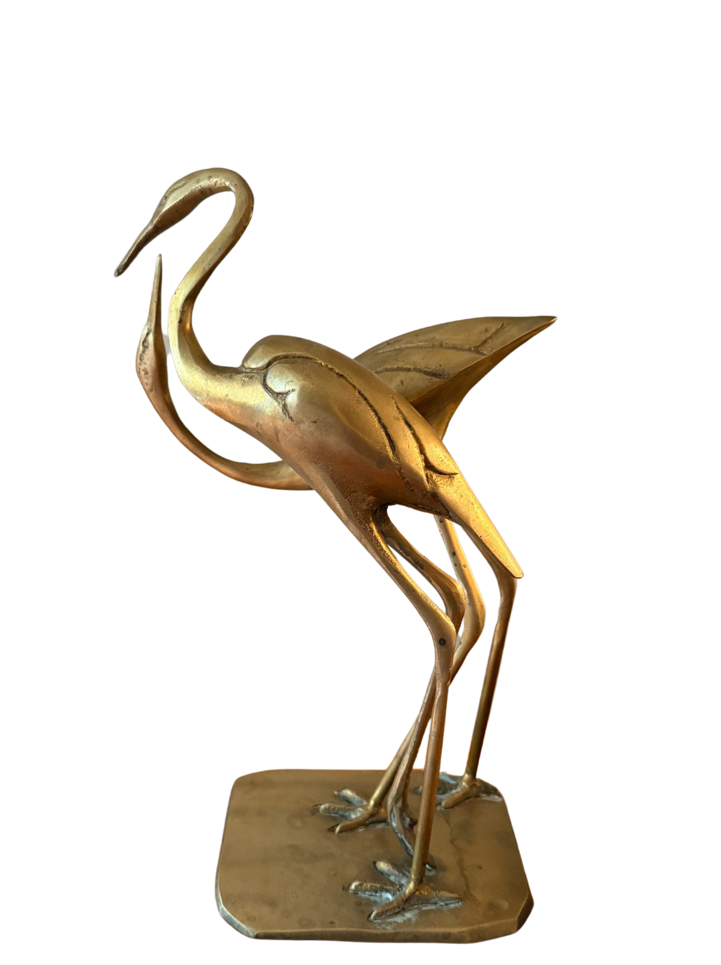 Side view of vintage brass crane pair statue, curved necks and textured wings, on shared base.