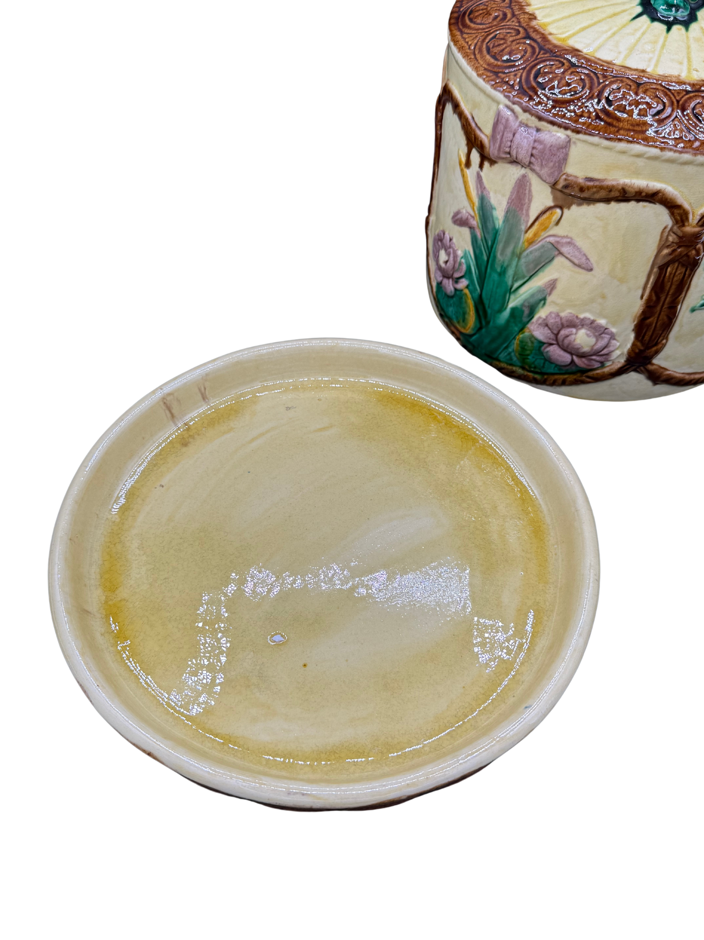 Interior base of antique majolica dome showing glazed yellow cream finish with signs of age