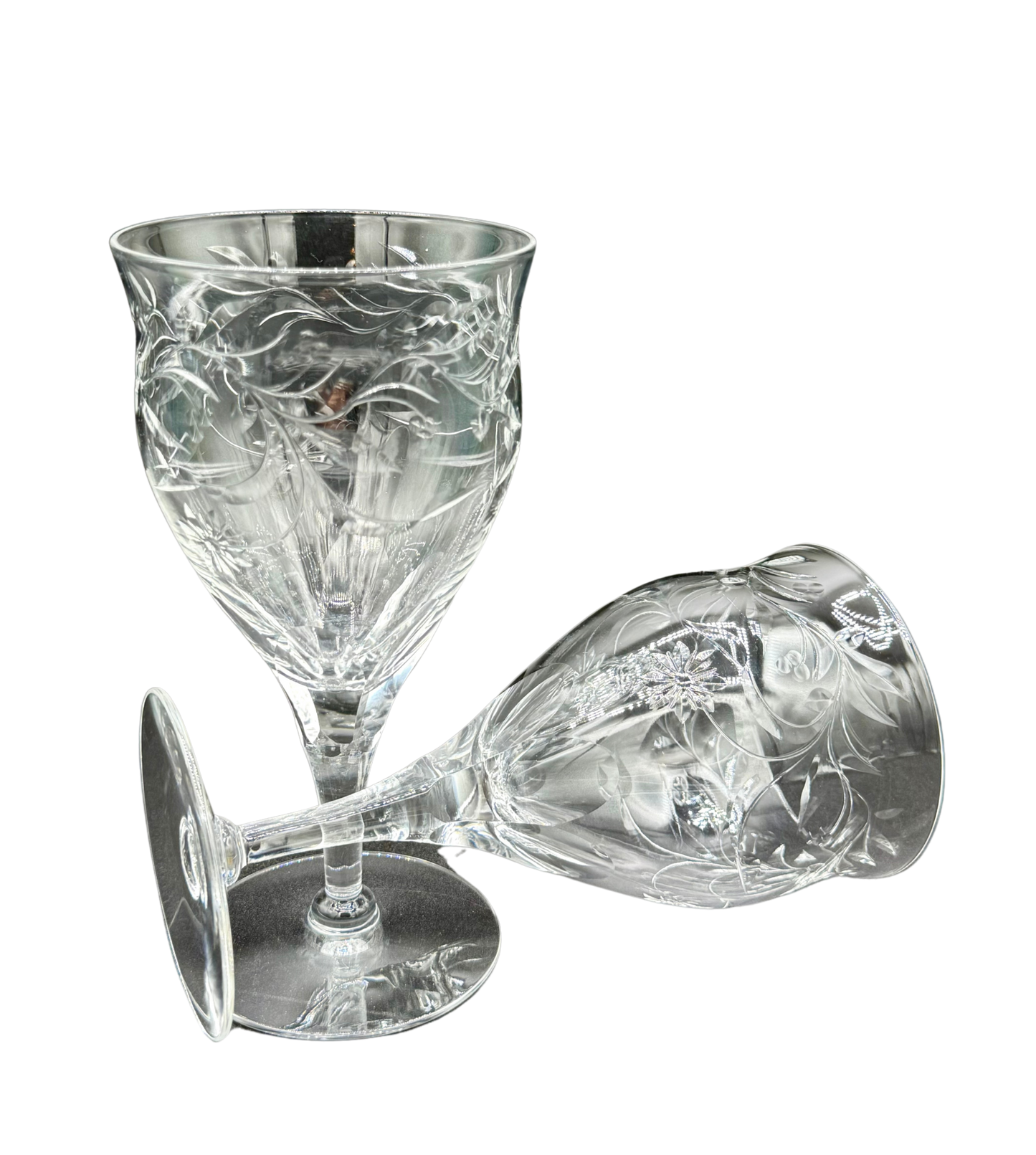 Close-up of vintage Seneca Crystal goblets showcasing floral etching and etched maker’s mark on base, crafted from luminous lead crystal.