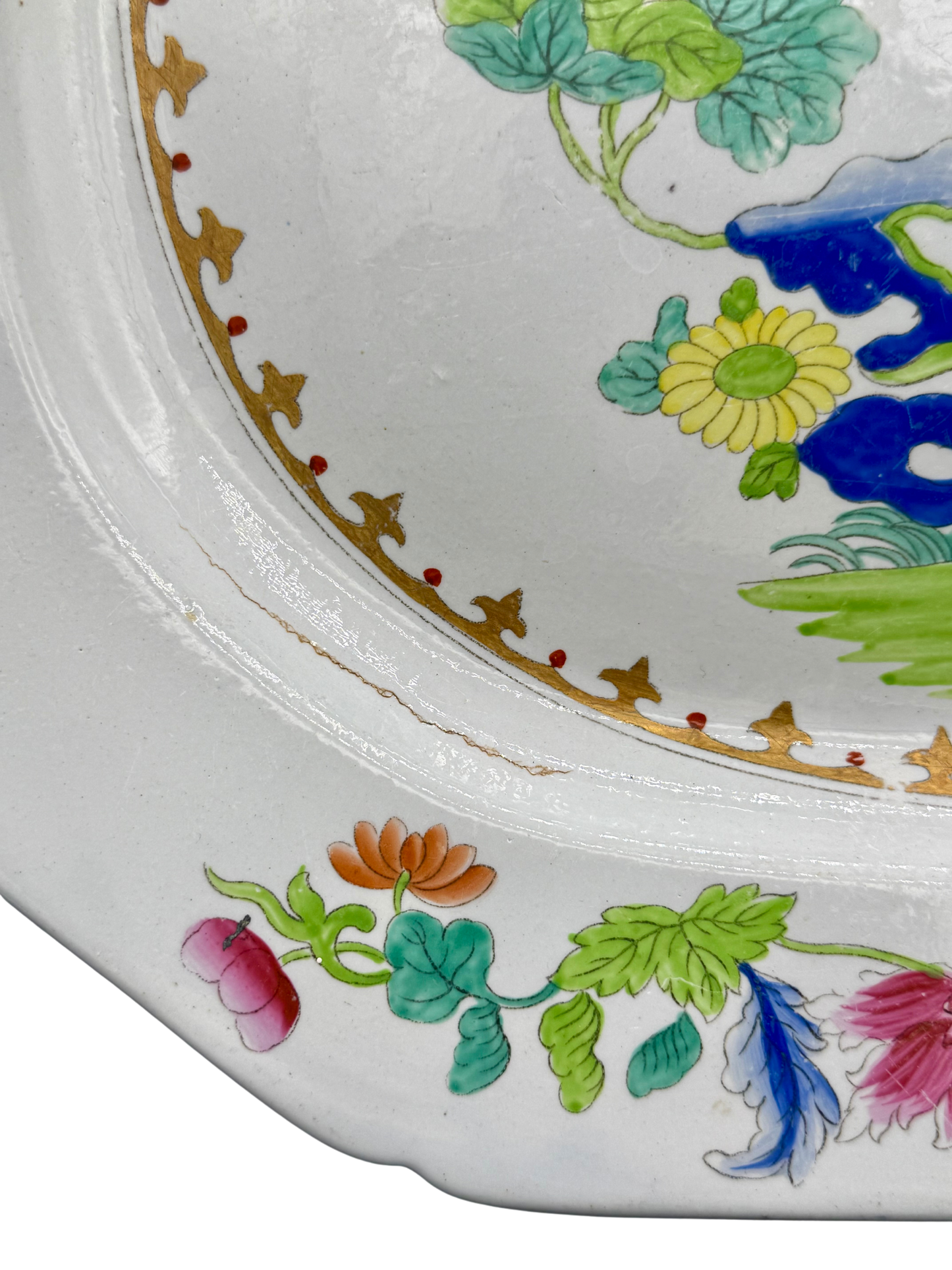 Detail of minor glaze crack on interior edge of Spode Stone China platter, surrounded by floral design.