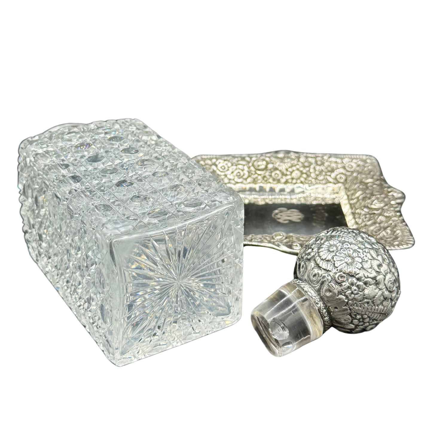 Side view of Tiffany & Co. decanter base with starburst cut crystal pattern, sterling tray, and stopper