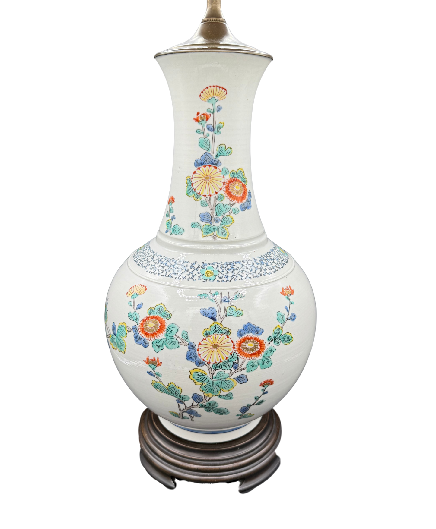 Angled view of white ceramic lamp featuring intricate floral motifs in red, blue, green, and yellow on wooden stand