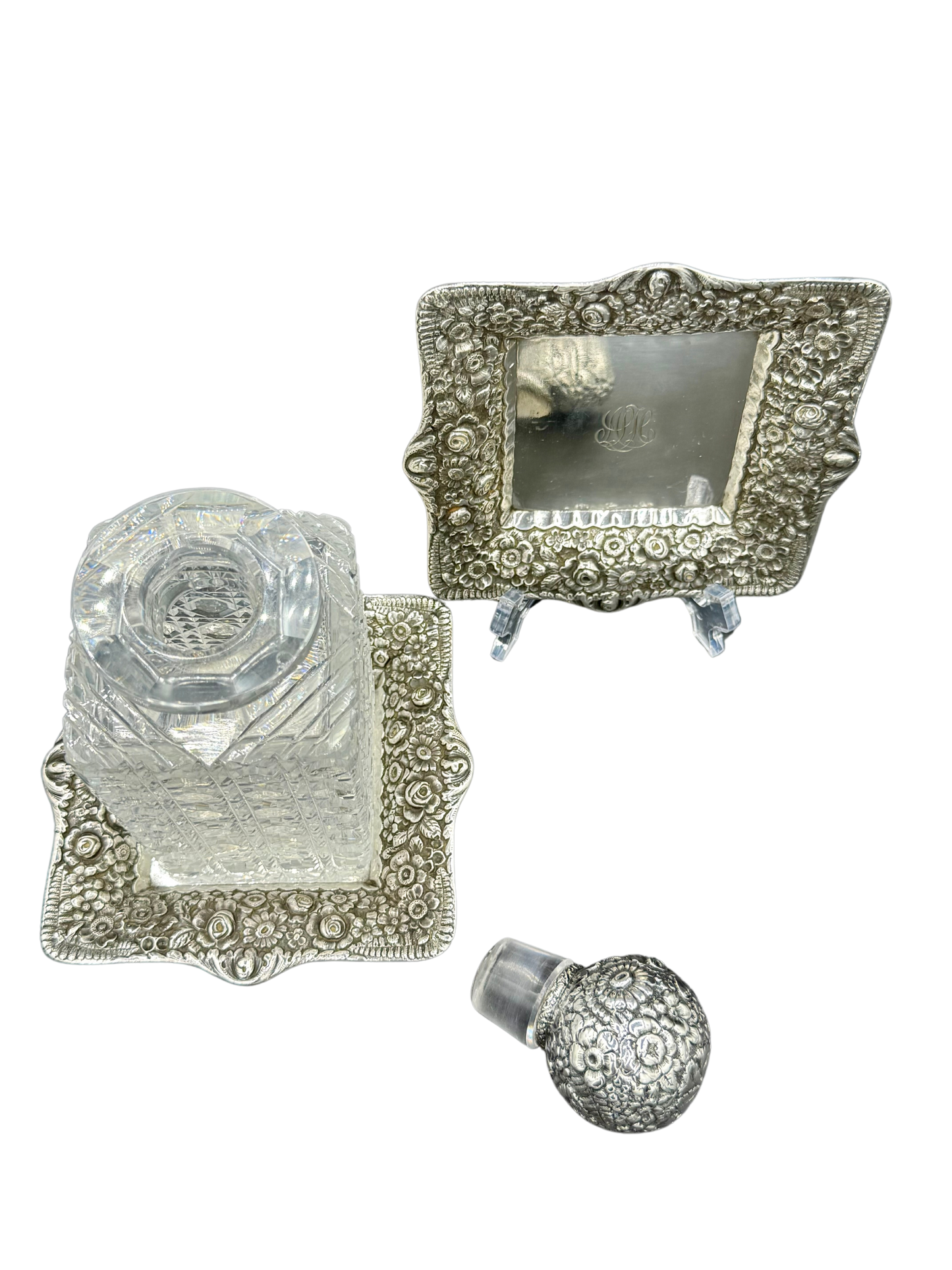 Overhead view of Tiffany & Co. crystal decanter and sterling trays in ornate floral repoussé pattern #8677