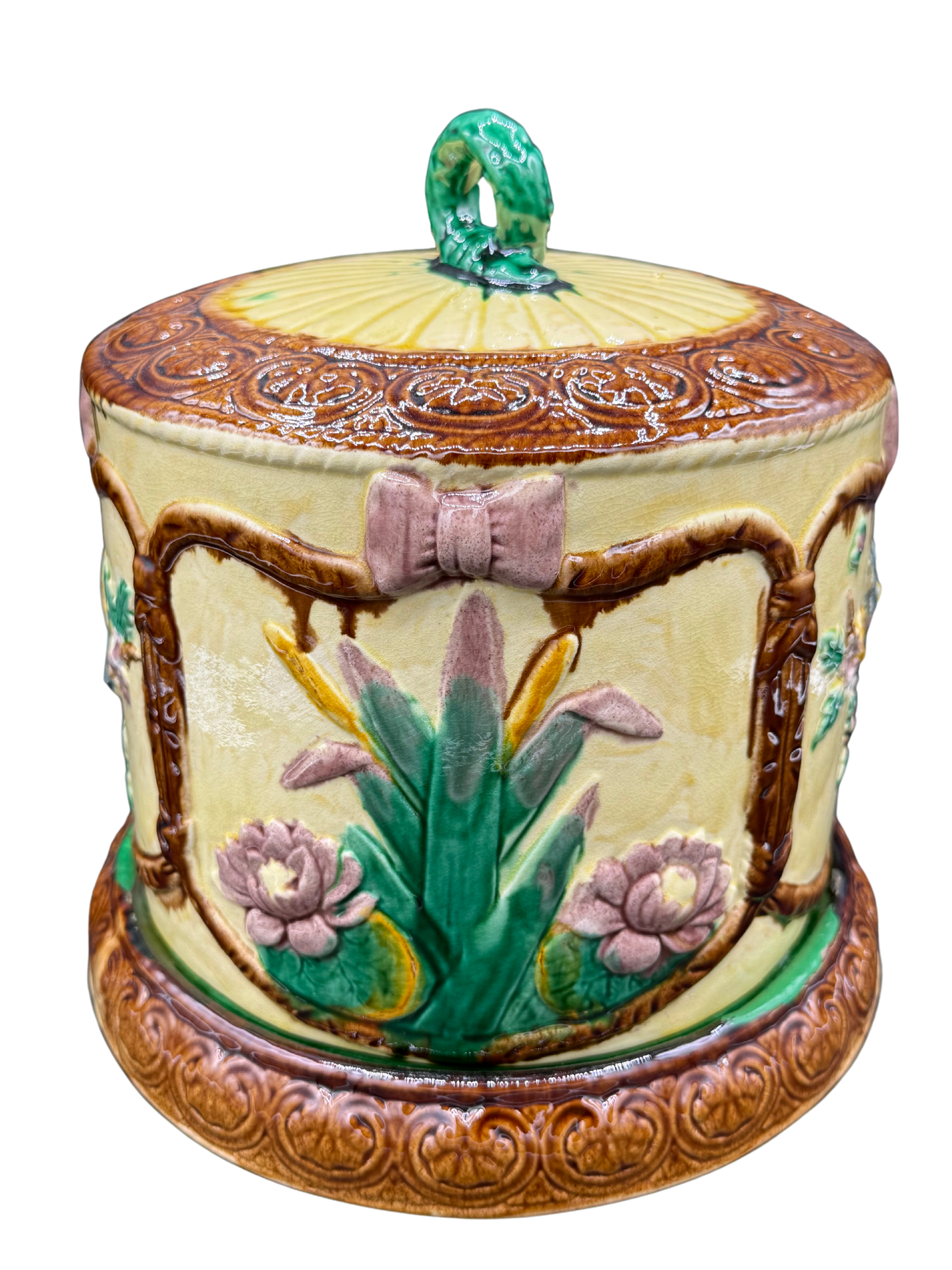 Side of Victorian cheese keeper with pink bow and iris motif in raised majolica glaze