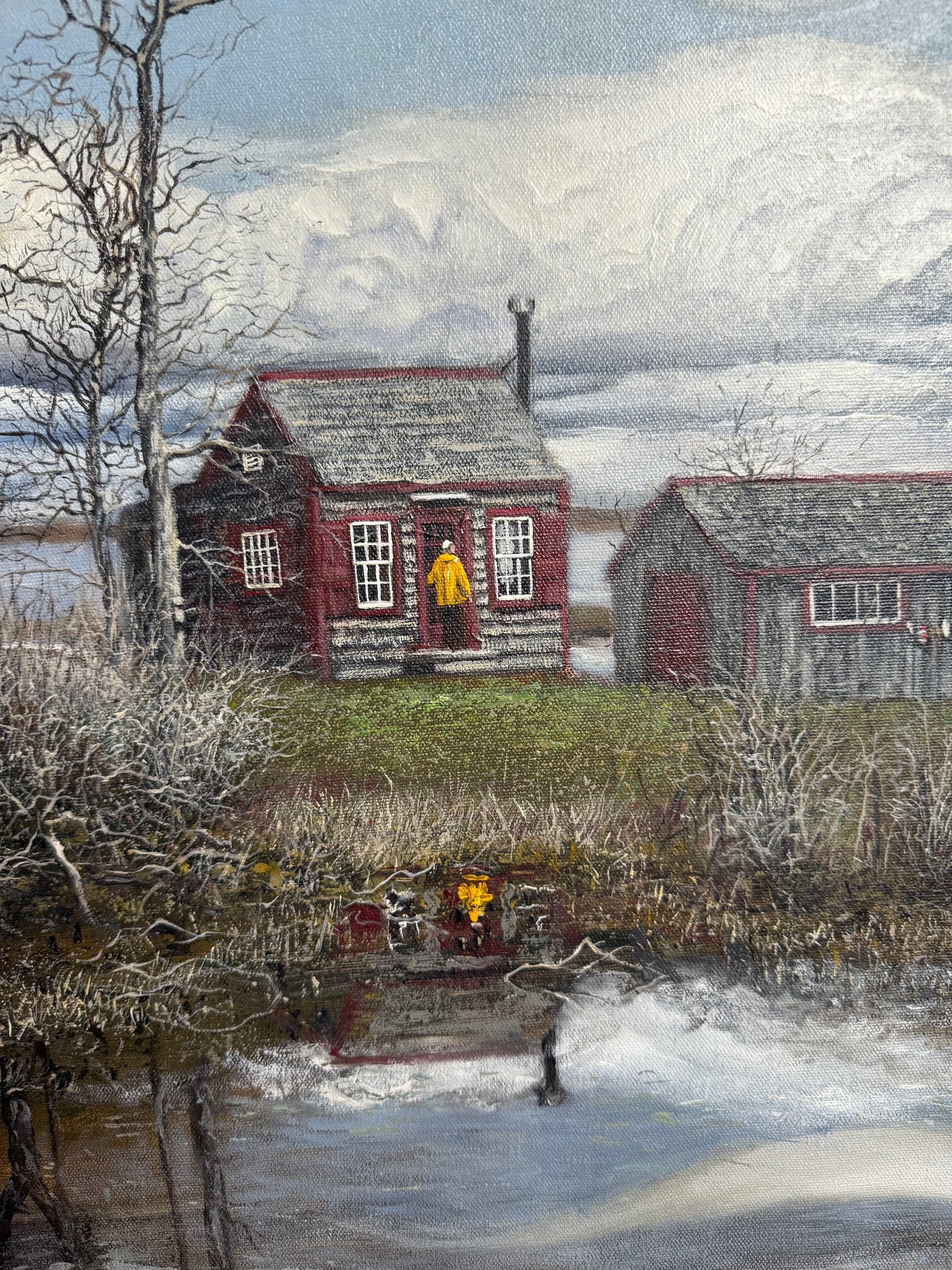 Yellow-coated figure in front of red house, reflected in water – Maine painting by George Gillens III