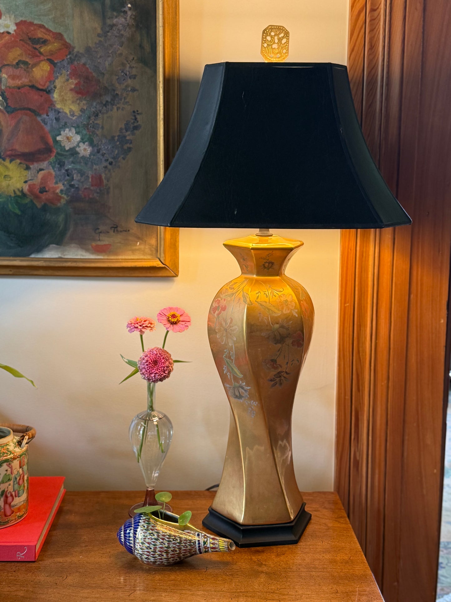Morris Greenspan floral porcelain lamp with black shade styled on wood table beside vintage artwork and fresh flowers