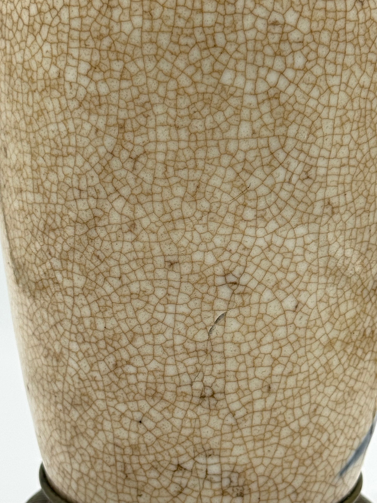 Rear view of early 20th-century French chinoiserie lamp with natural crackle glaze, blue floral accents, and a small repaired crack.
