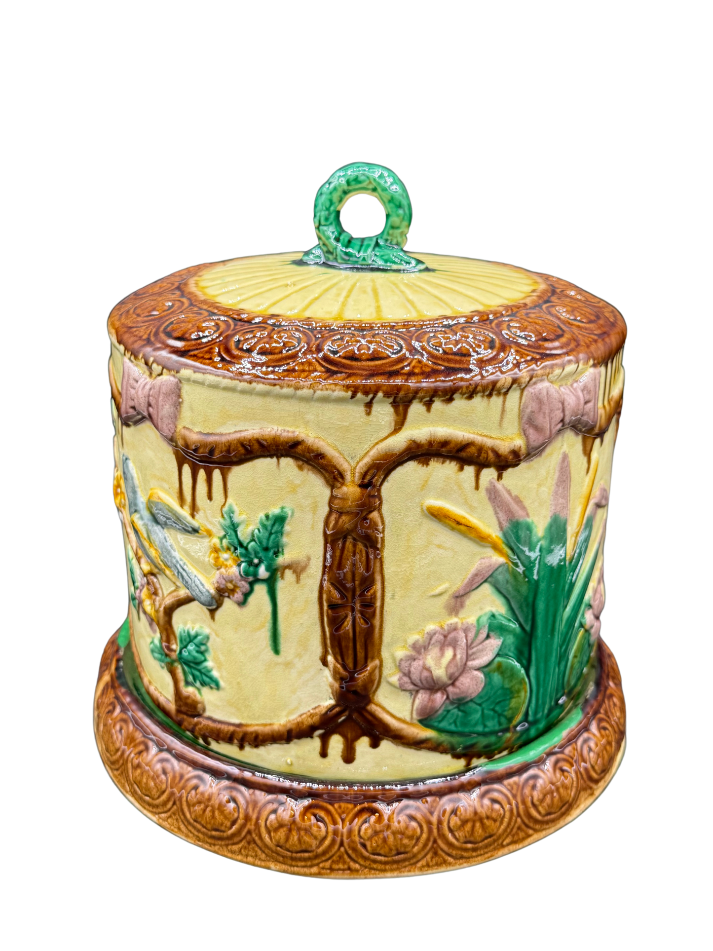 Back view of antique majolica cheese dome showing botanical design and scrolled border