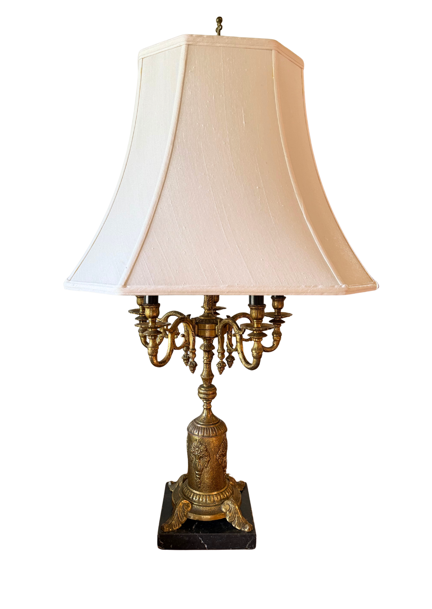 Vintage French-style candelabra table lamp with ornate brass detailing, six candle-style light sockets, and cream pagoda lampshade on black background.