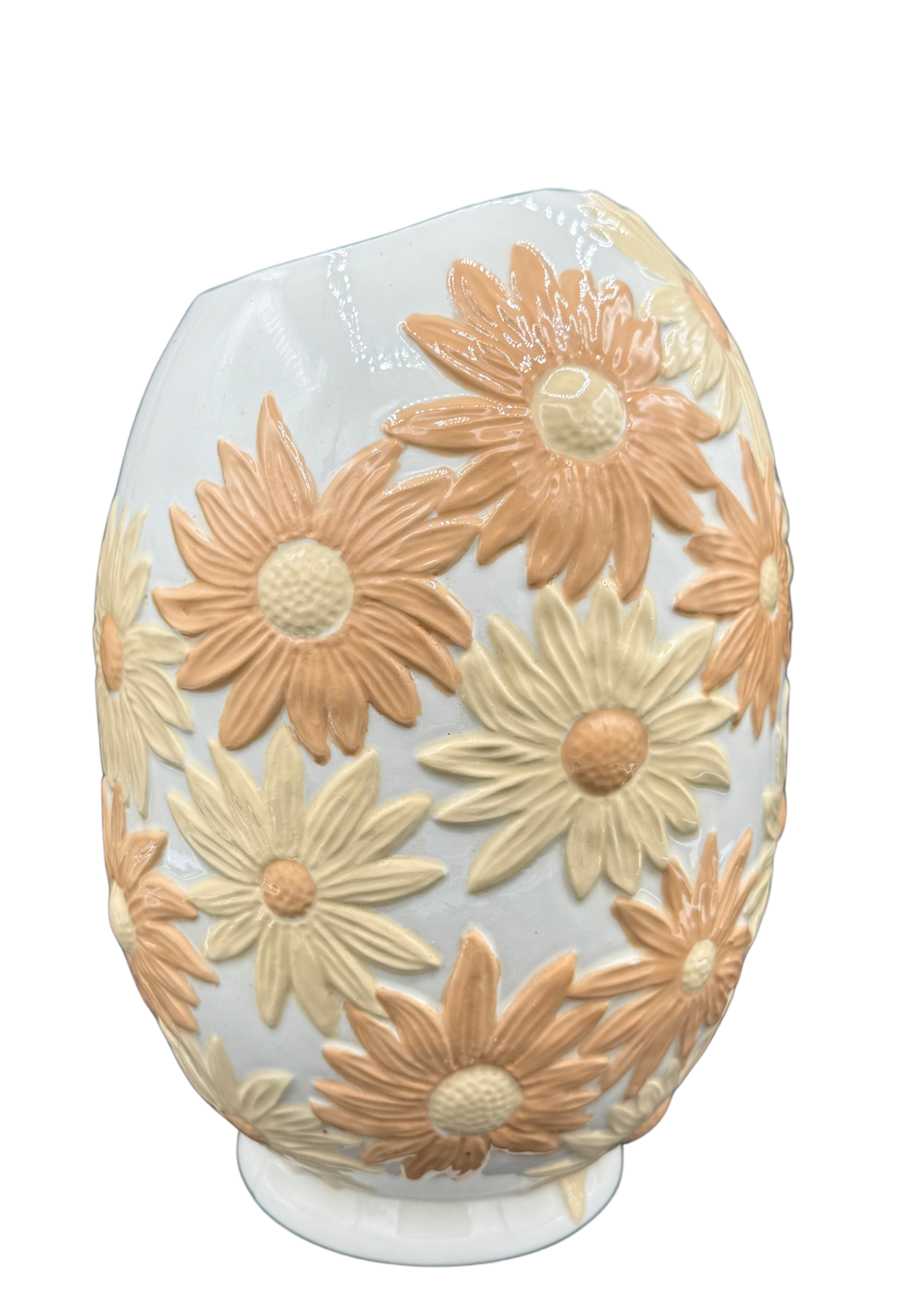 Side view of large vintage floral ceramic vase with raised daisy pattern and asymmetrical rim.