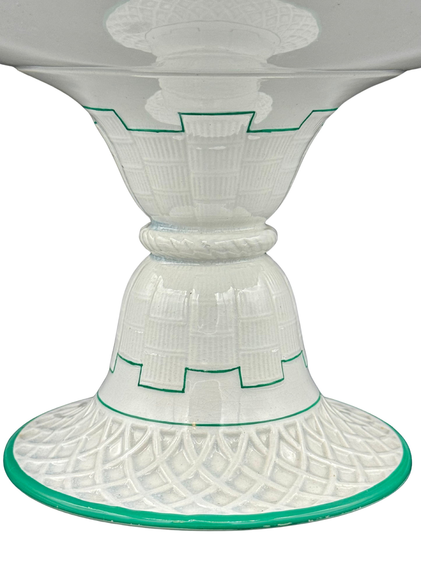 Close-up of antique Minton cake stand pedestal showing architectural molding and green line accents