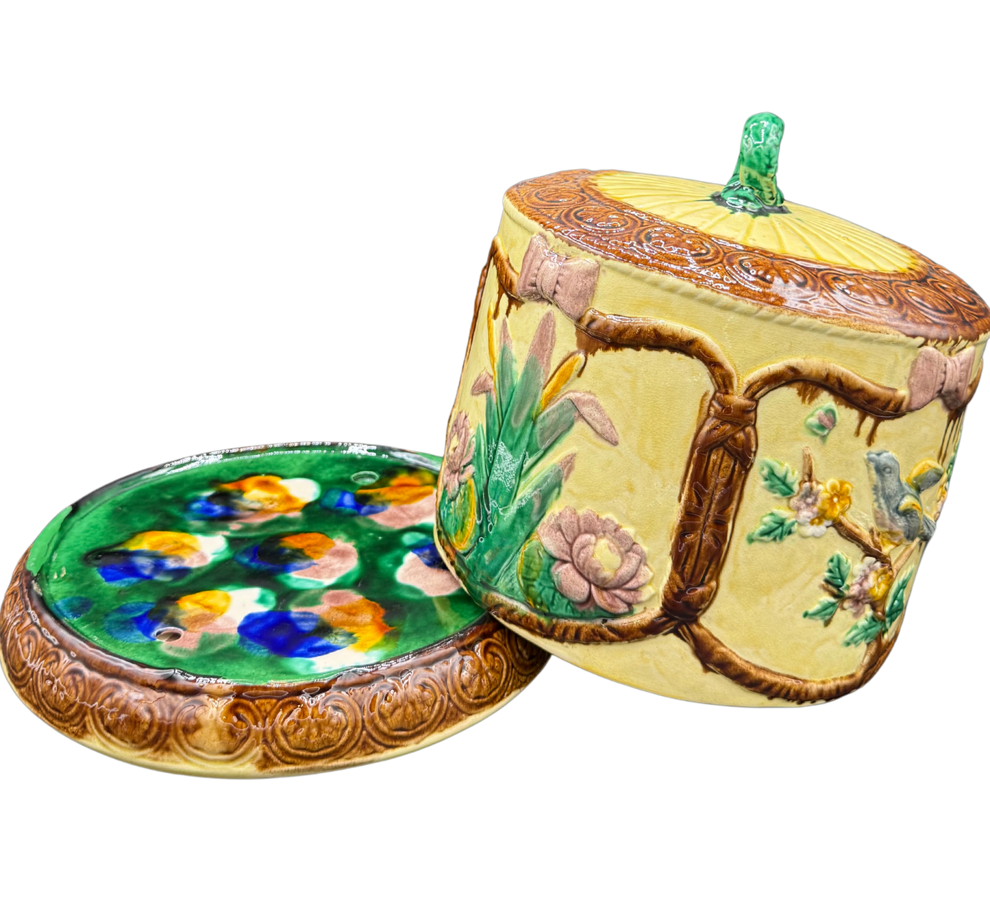Lid removed from 19th-century majolica cheese dome revealing vibrant hand-painted majolica base