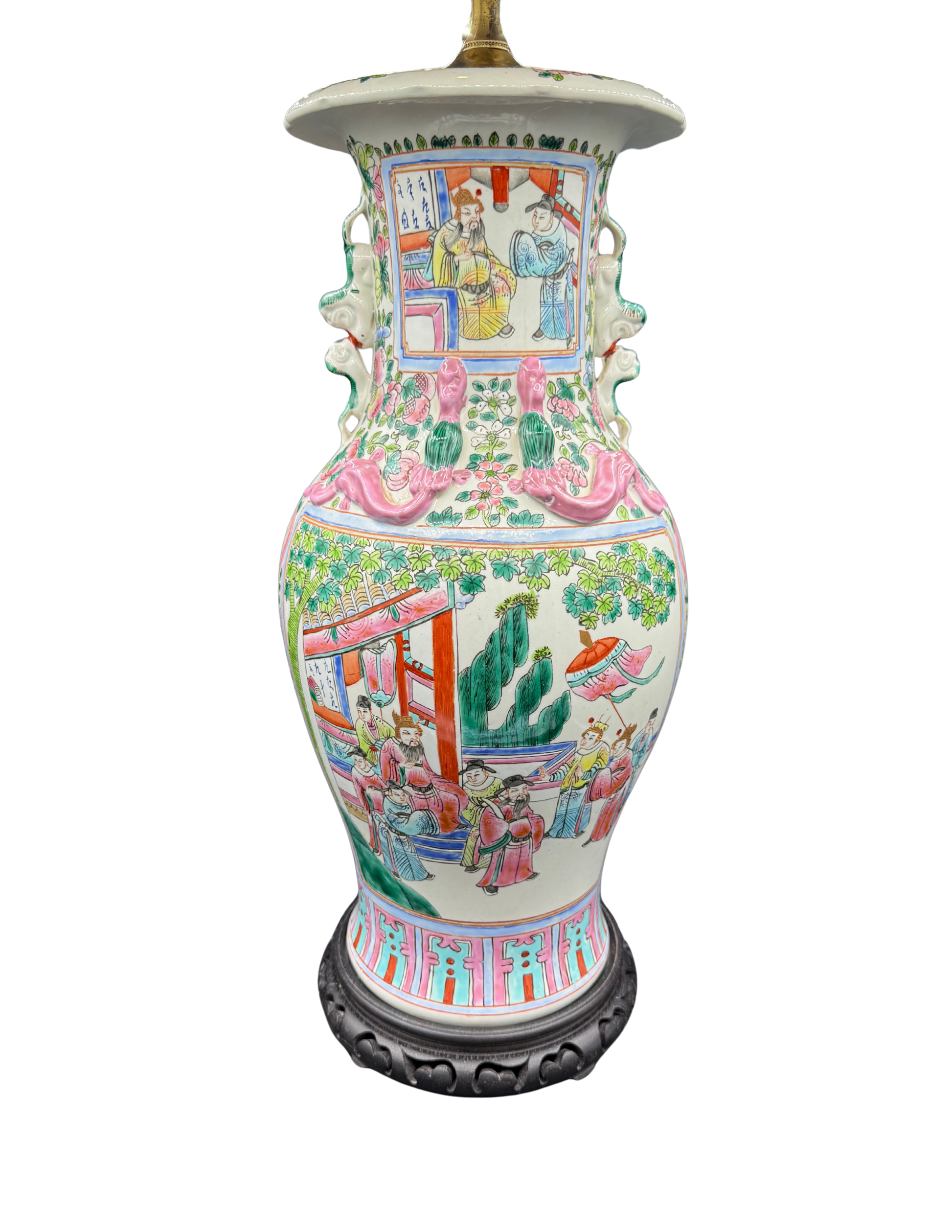 Hand-painted Chinese famille rose porcelain table lamp with rose medallion pattern, foo dog handles, and high-relief dragon motifs on pagoda-style wooden base.