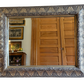 “Antique silver-leaf gilt wood mirror with beveled glass, ornate floral and foliate carved frame, 43 inches wide by 34 inches tall”