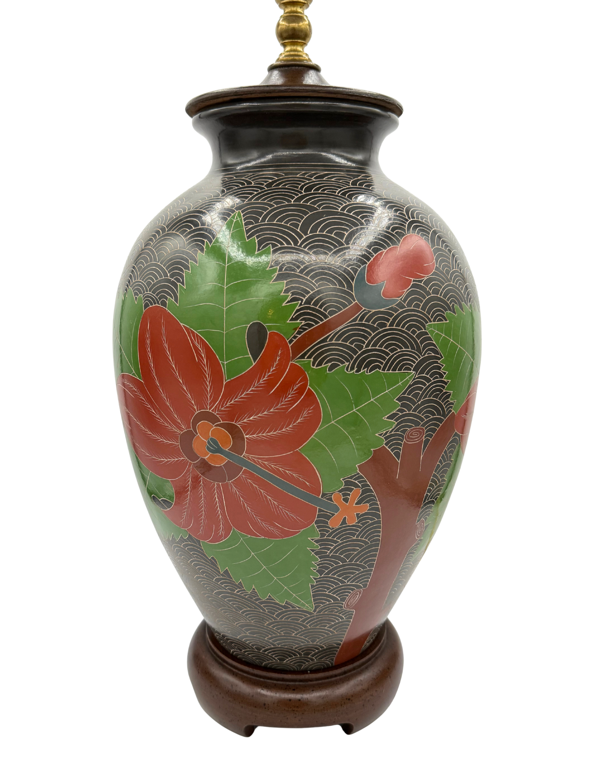Full front view of vintage sgraffito ceramic lamp with carved floral design and brass light fitting on wood base
