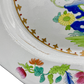 Detail of minor glaze crack on interior edge of Spode Stone China platter, surrounded by floral design.