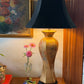 Morris Greenspan floral porcelain lamp with black shade styled on wood table beside vintage artwork and fresh flowers