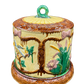 Back view of antique majolica cheese dome showing botanical design and scrolled border