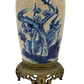 Lower portion of antique French table lamp featuring vibrant blue botanical motifs, crazing, and detailed brass footed base