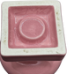Underside view of vintage Fiestaware pink candle holder, showing marked ceramic base and midcentury glaze detail - marked Fiesta and USA