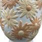 Close-up showing textured glaze and petal detailing on vintage daisy vase.