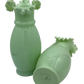 Side angle of vintage pale green opaline vases with fluted edges and subtle variations in color and form, typical of early 20th-century craftsmanship.