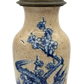 Close-up of French ceramic lamp showing hand-painted prunus blossoms in cobalt blue with visible minor crack in glaze.